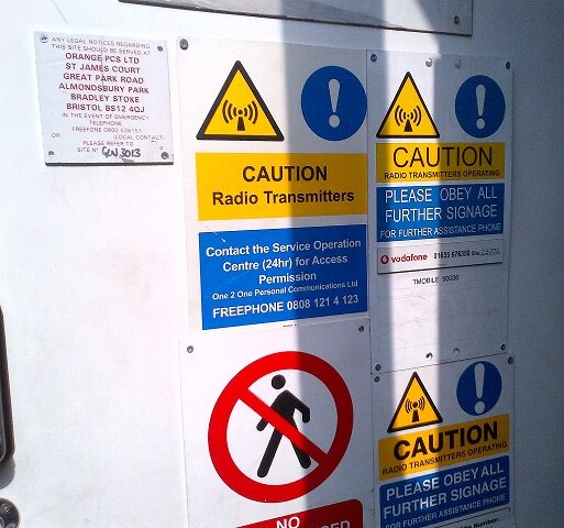 Warning labels at the base of a Telecoms Mast